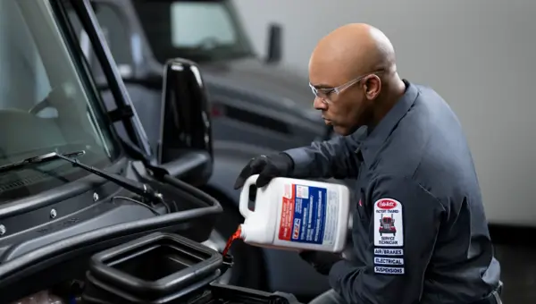 PB Service Tech Pouring Coolant Image